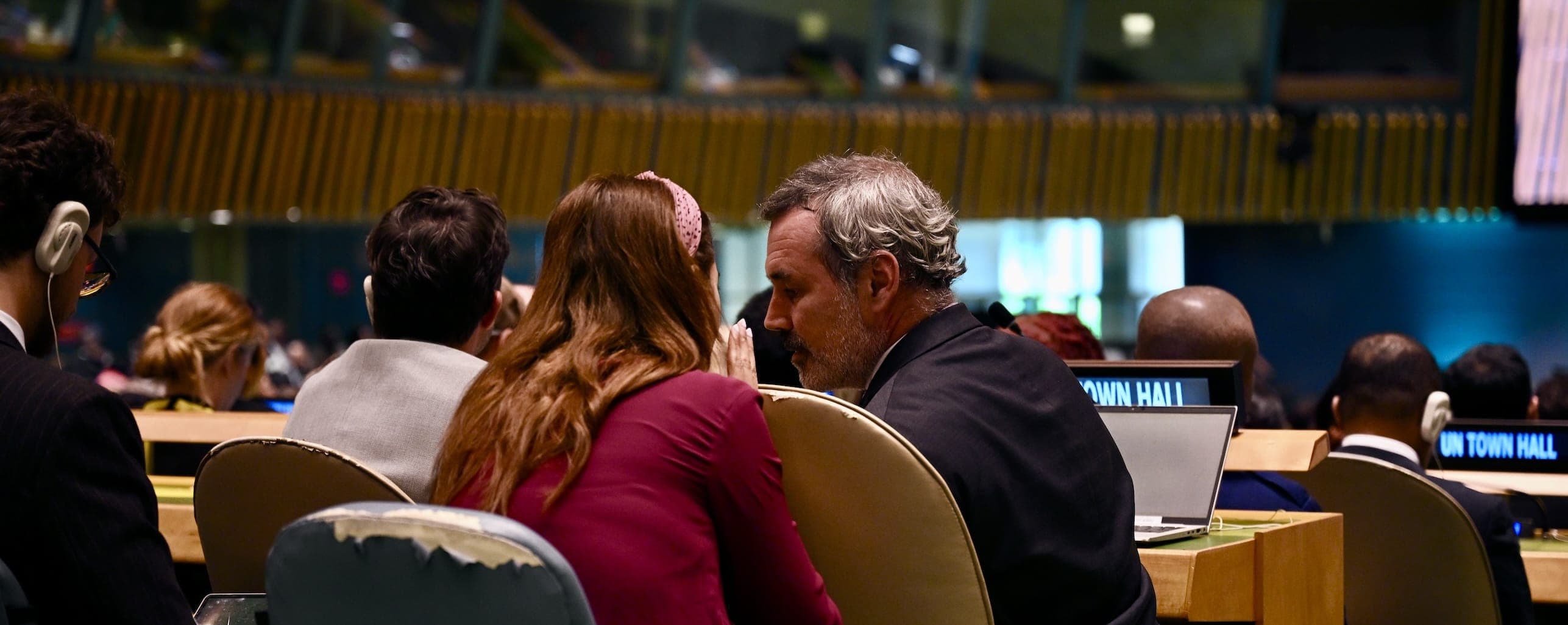 Delegates confer during a United Nations town hall in the General Assembly Hall.
