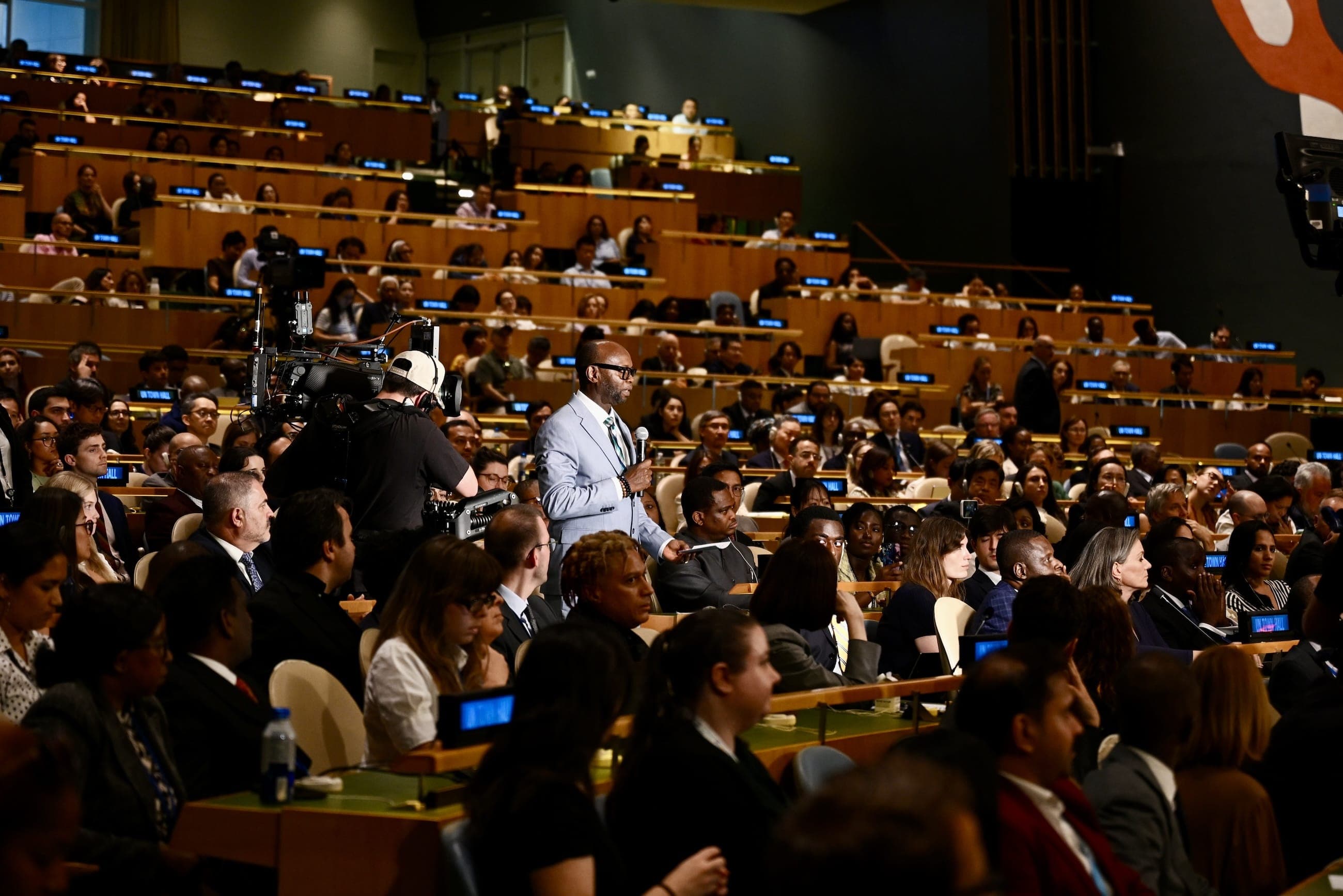 The General Assembly Hall illuminated for the United Nations eightieth anniversary under the words Building Our Future Together.