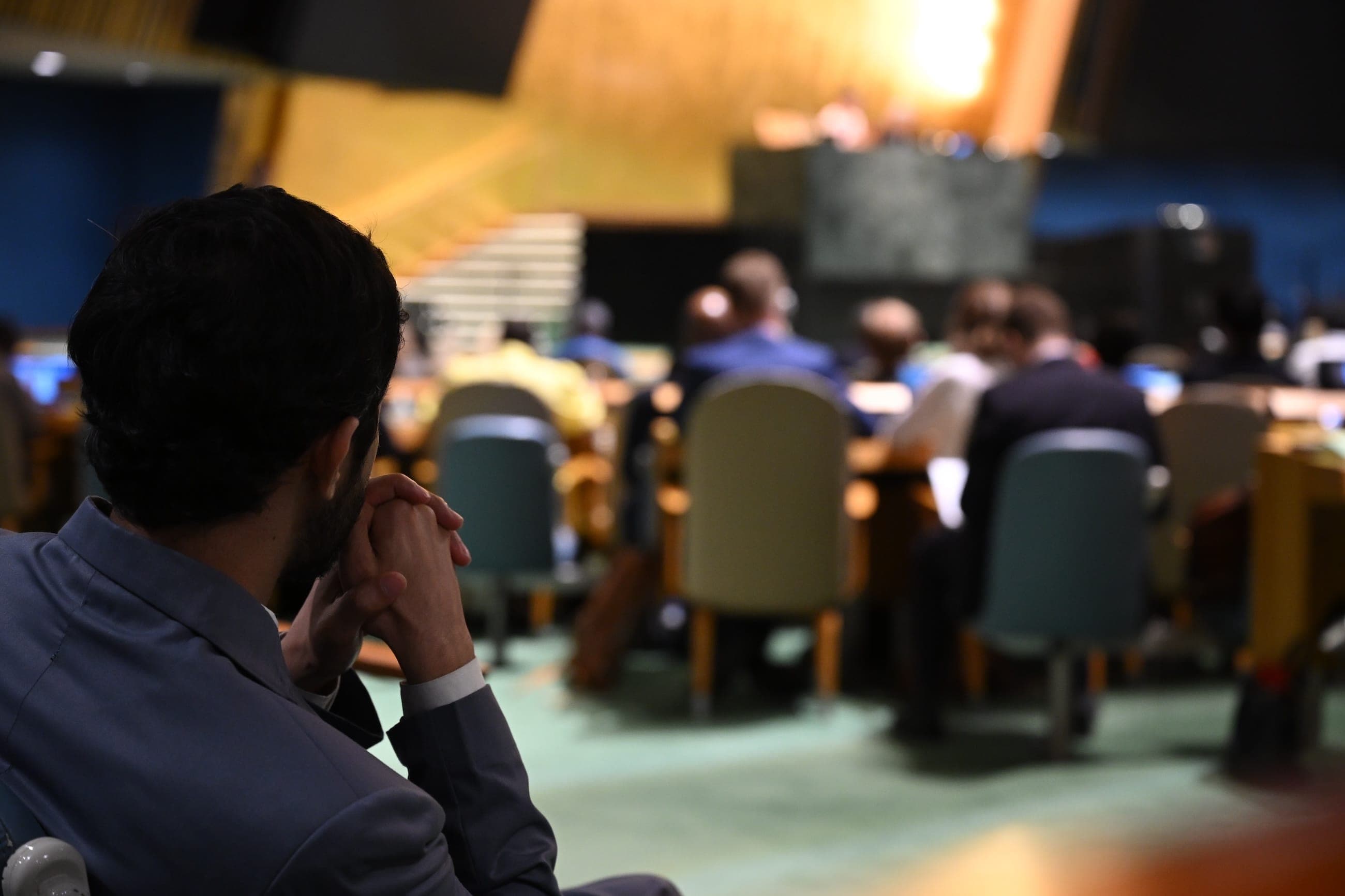 A delegate watches proceedings from his seat in the General Assembly Hall.