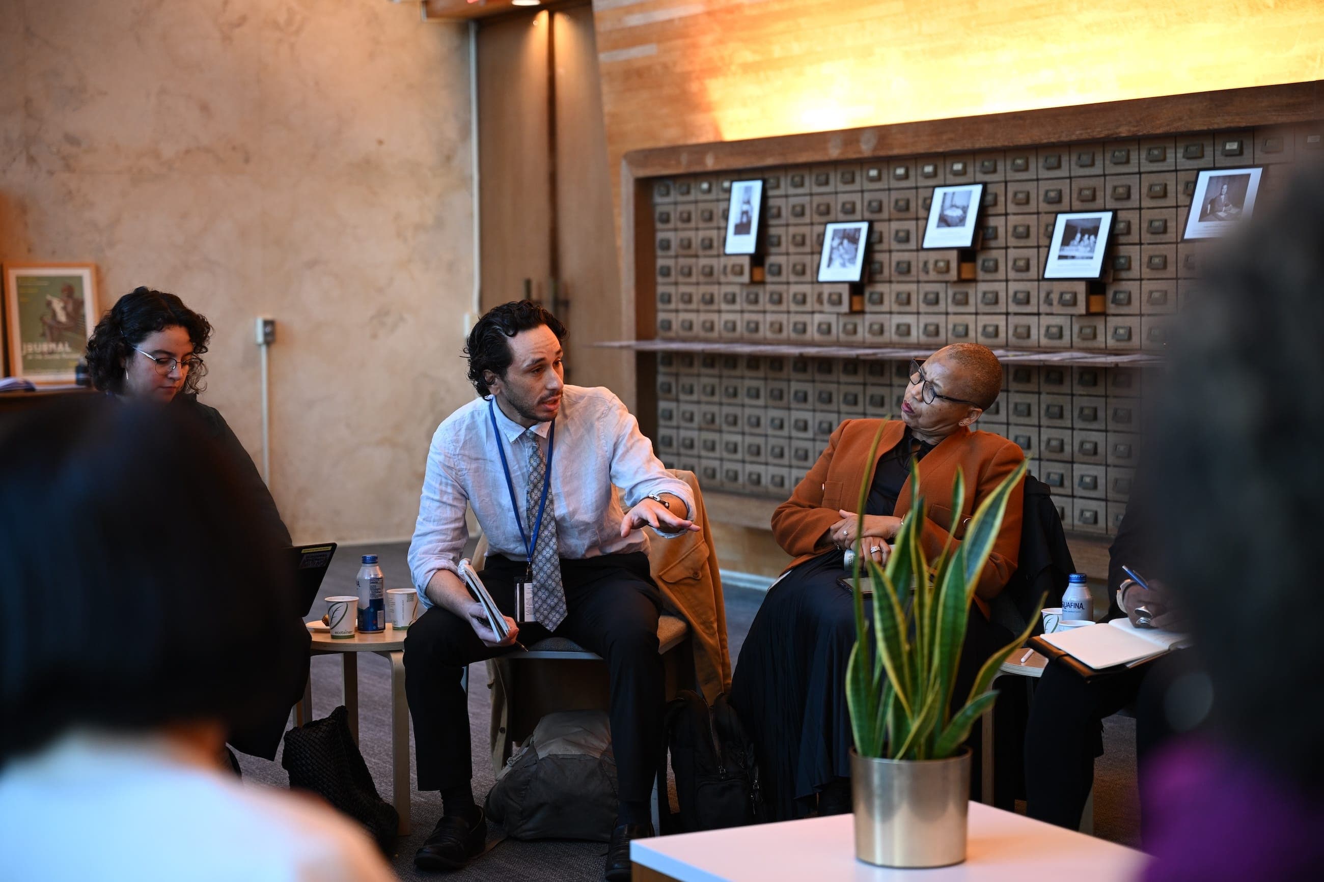 Participants exchange views during a small-group discussion in the United Nations Goals Lounge.