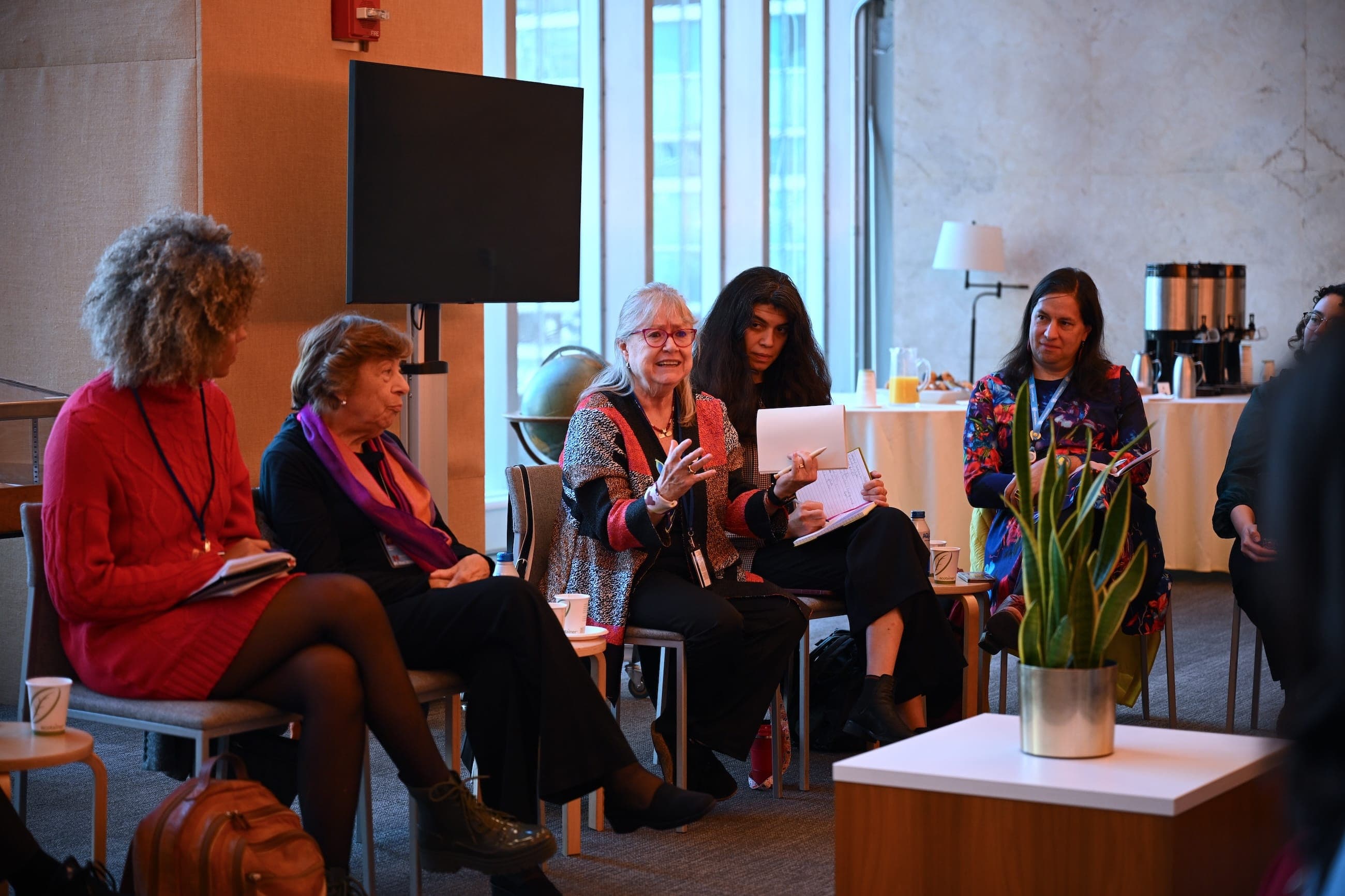 Five women take part in a seated discussion in the United Nations Goals Lounge.