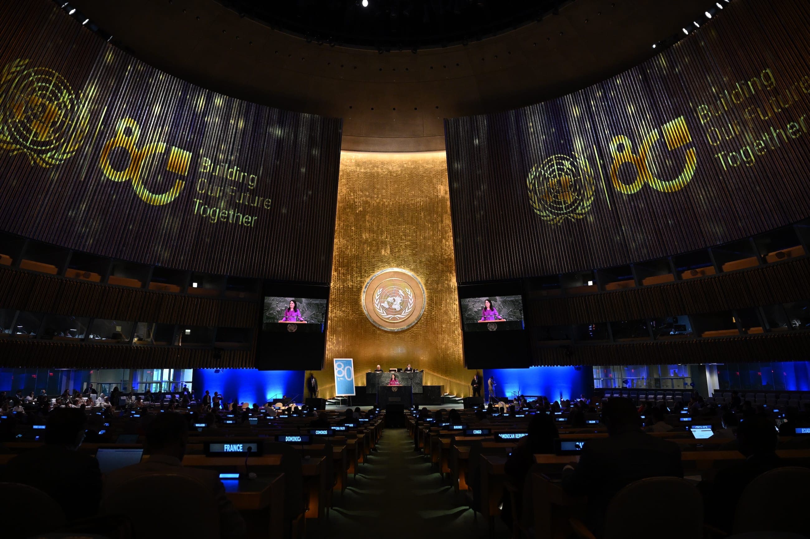 An attendee records the United Nations town hall on a phone from the General Assembly Hall.